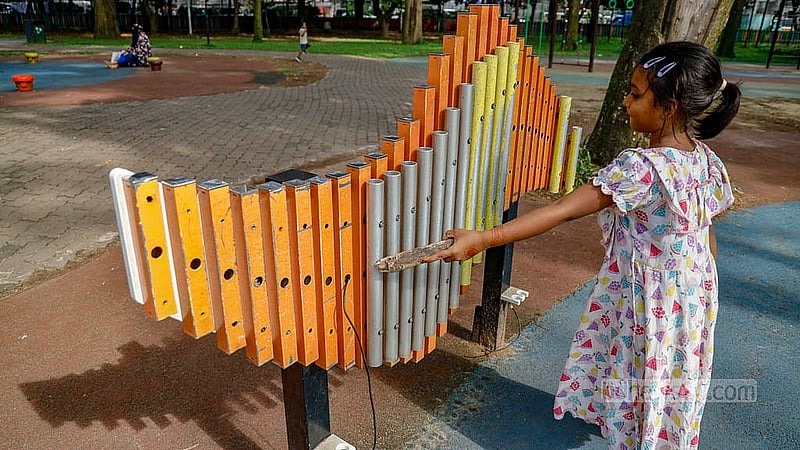 The xylophone at Ramna Park’s children’s corner is unusable, its strings torn off and its mallets missing. A child uses a piece of wood to play with it instead. Photo: Mahmud Zaman Ovi