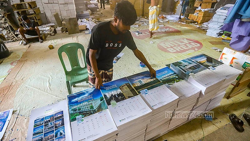Calendar pages are being organised per the order of months at a printing house in Dhaka’s Matuail. Photo: Abdullah al Momin