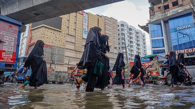 Local residents navigate on a road in Mirpur submerged by continuous rain on Sunday, Aug 17, 2025. Photo: Mahmud Zaman Ovi