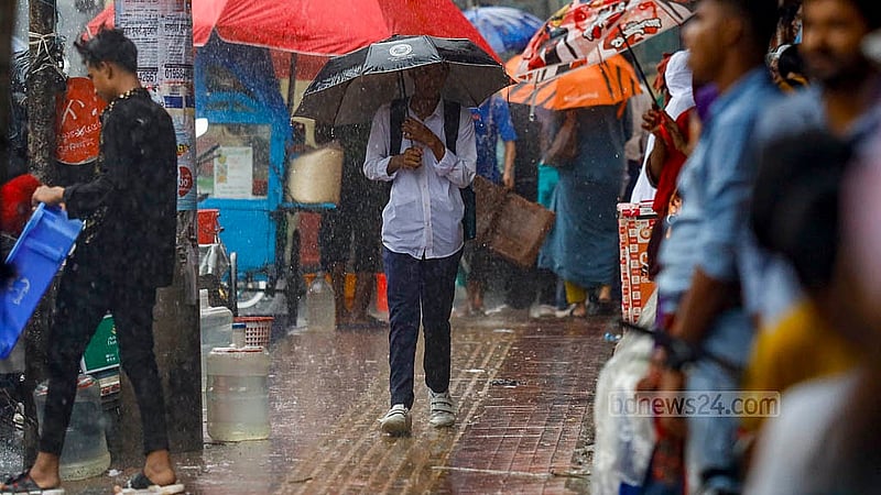 A student carrying an umbrella walks through rain at Mohammadpur bus stand in Dhaka on Monday, Jul 1, 2024. Photo: Mahmud Zaman Ovi