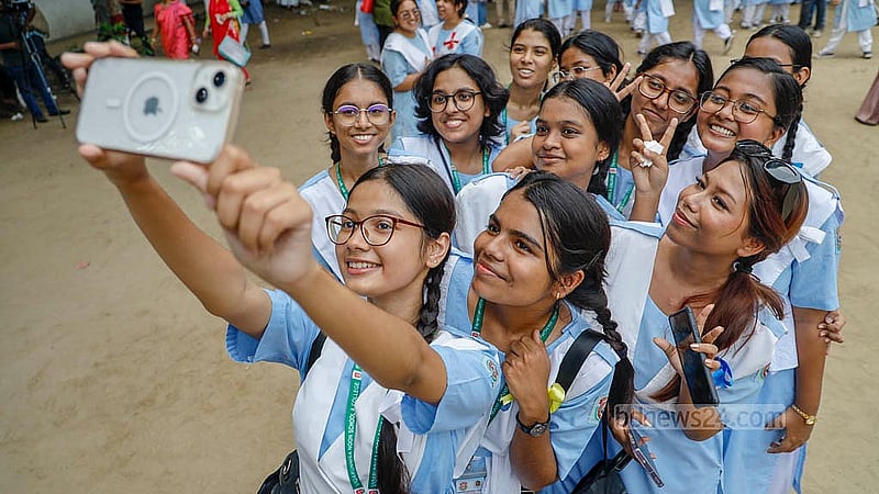 Students of Viqarunnisa Noon School and College capture the moment of SSC result celebrations on their mobile phone on Sunday, May 12, 2024.