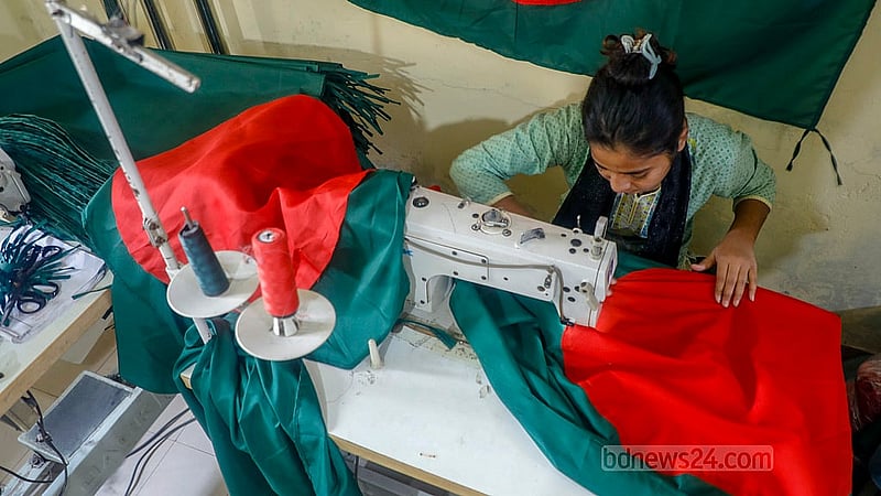 Workers in Merajnagar stitch red circles onto green fabric as part of the flag-making process.Photo: Abdullah Al Momin