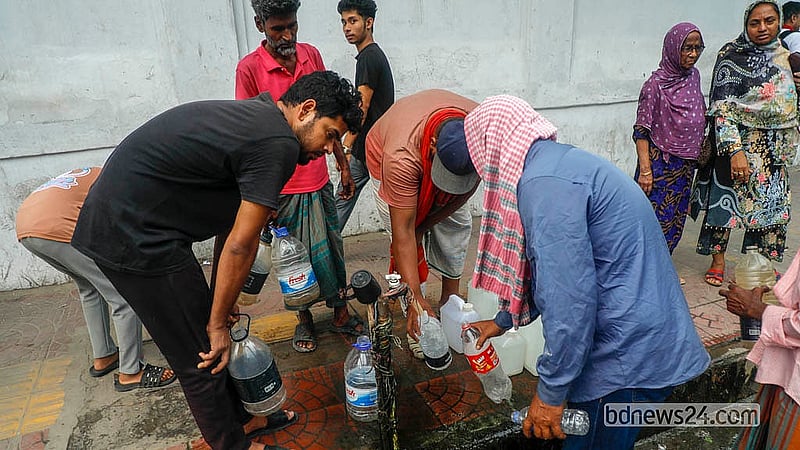 Many people fill up on drinking water at a tap on the footpath in front of the Bangabhaban Colony’s No. 5 gate on Dhaka’s Ittefaq Intersection. Photo: Abdullah Al Momin