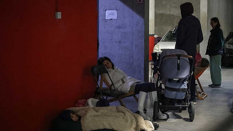 People take shelter inside an underground parking lot during Russian drone and missile strikes, amid Russia's attack on Ukraine, in Lviv, Ukraine Oct 5, 2025. REUTERS/Roman Baluk