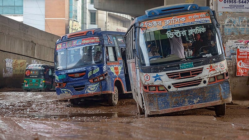 Cars tilt sharply from side to side as they pass over gaping potholes under the BRT flyover in Abdullahpur, a daily occurrence for commuters.Photo: Mahmud Zaman Ovi
