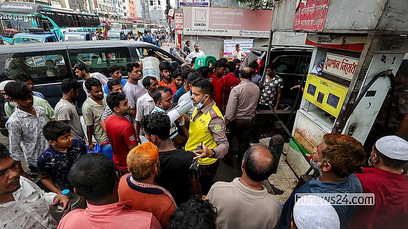 A police officer tries to manage the crowd as people line up for diesel for generators at a filling station in Dhaka’s Uttar Badda on Wednesday, Apr 15, 2026.