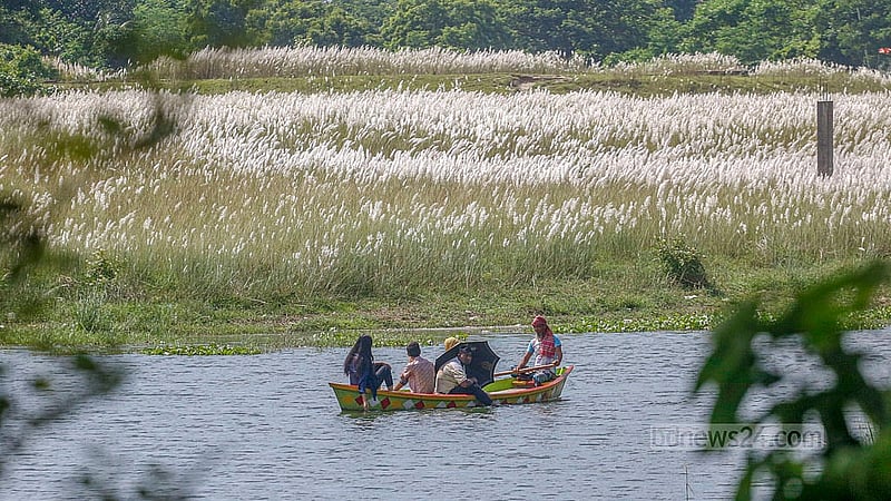 Several people enjoy the beauty of Kashful while riding a boat at Keraniganj’s Sarighat.