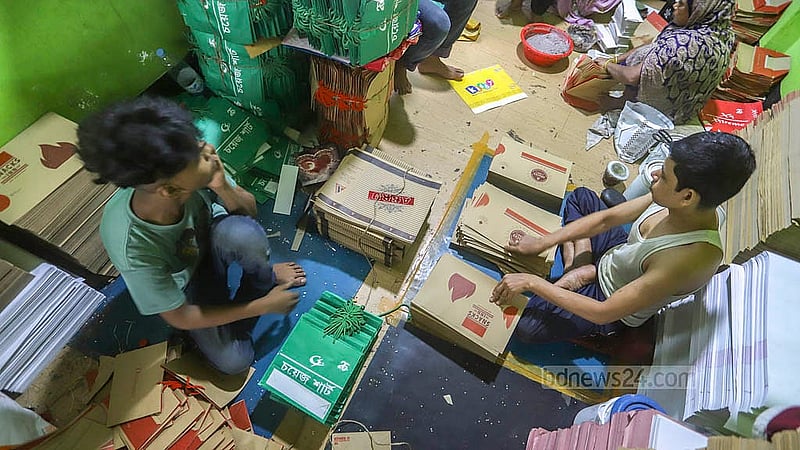 Workers are busy making paper shopping bags. This busyness is evident in a factory located in the Shahid Nagar of Dhaka’s Keraniganj. Photo: Abdullah al Momin