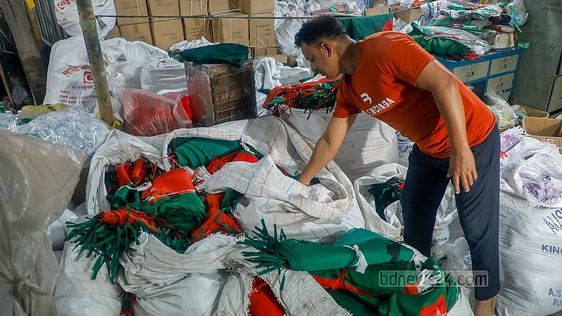 Stacks of completed flags are piled up inside a Kadamtali workshop, ready for sale ahead of Victory Day.Photo: Abdullah Al Momin