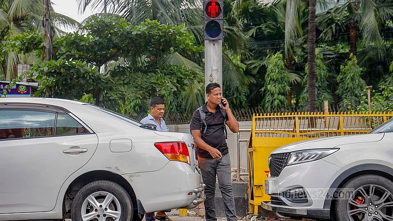 There are designated places for pedestrians to cross the road and red and green traffic signals to tell them when to go. But no one follows the signal. Photo: Mahmud Zaman Ovi