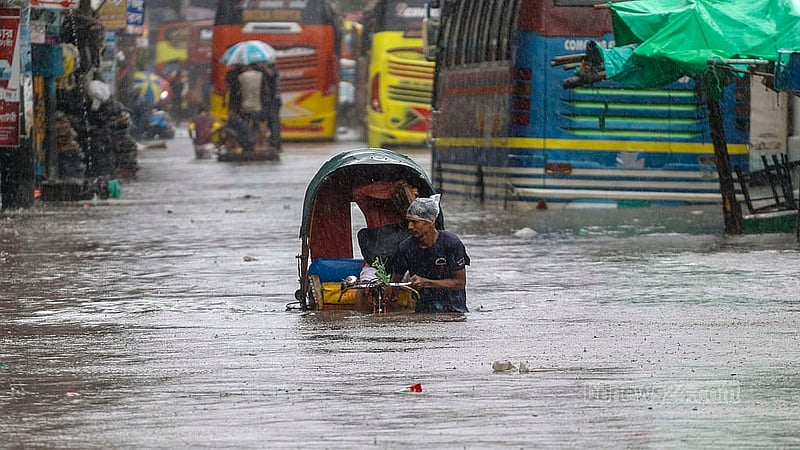 A driver tries to navigate a rickshaw through the waist-high water at Dhaka’s Sayedabad after a day of heavy rain brought on by Cyclone Remal causes waterlogging. Photo: Muhammad Mostafigur Rahman