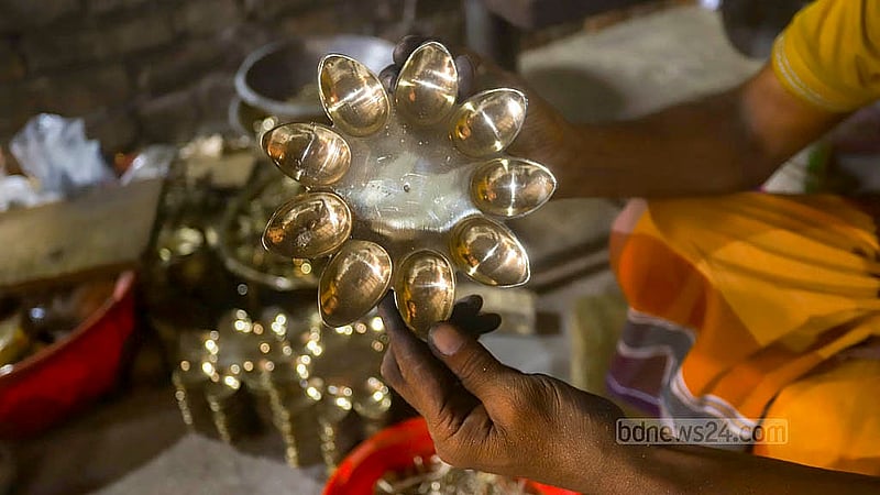 A brass lamp with a peacock design is being produced at a factory in Jhaulahati in Dhaka’s Kamrangirchar. Photos: Abdullah Al Momin