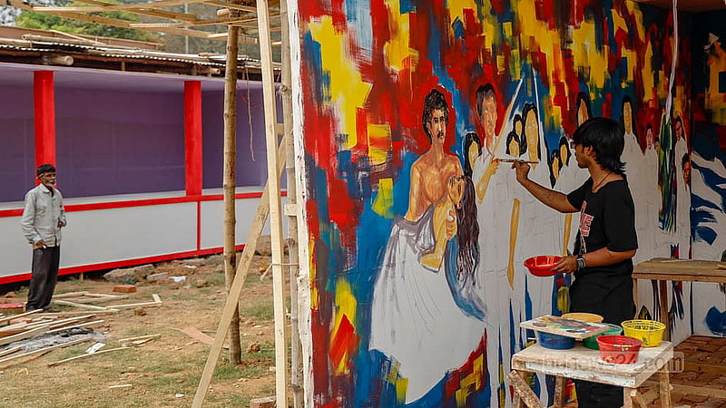 Artists paint murals on the wall of a stall at Suhrawardy Udyan as the finishing touches are added before the fair begins. Photo: Mahmud Zaman Ovi