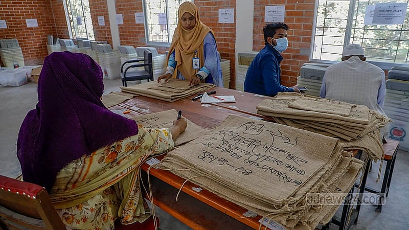 Centre details are being written on a burlap bag for the national election at the Azimpur Government Girls’ School and College centre in Dhaka on Monday, Feb 9, 2026. The bags will be sent to polling stations along with ballot boxes. Photo: Mahmud Zaman Ovi