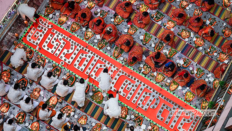 At sunset, as the bells ring, everyone lights their lamps together to the sound of devotional ululation, a traditional sound made by Hindu women to signify joy and good fortune. Photo: Muhammad Mostafigur Rahman