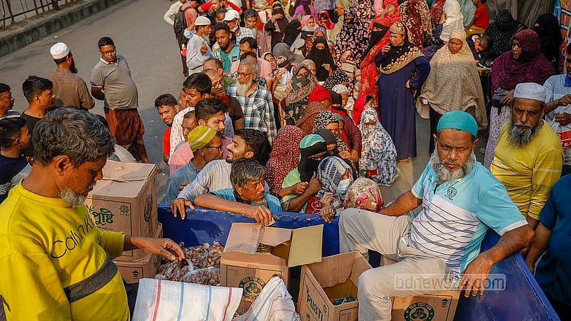 Near the Town Hall of Dhaka’s Mohammadpur, buyers stand in line for hours in the scorching sun on Wednesday, Feb 18, 2026, to buy products from Trading Corporation of Bangladesh (TCB) trucks, as they offer daily necessities at a lower price. Photo: Mahmud Zaman Ovi