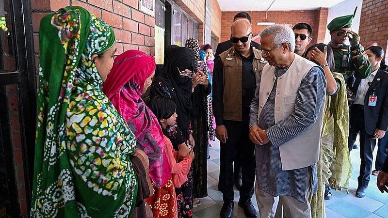 After voting at the Gulshan Model School and College centre, Muhammad Yunus speaks with voters outside the polling station. Photo: PID