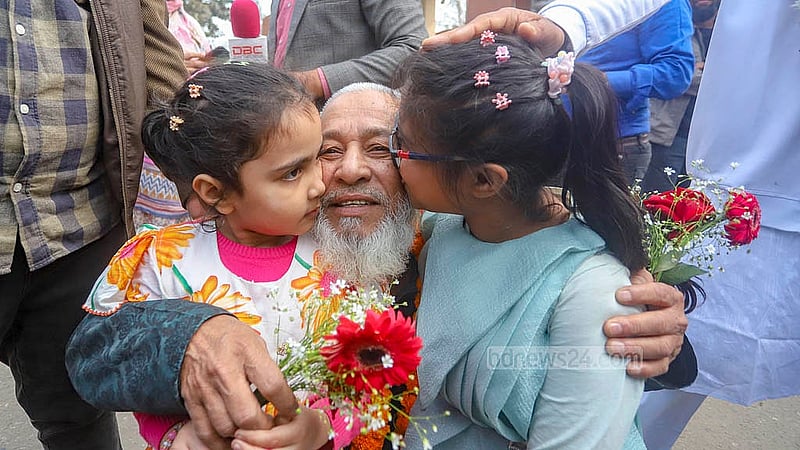 BDR Engineer Corps member Muzaffar Hossain becomes emotional as he hugs his two grandsons, one of whom garlands him. Photo: Abdullah al Momin