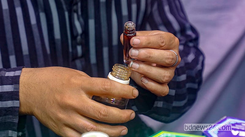 Customers buy attar from a shop outside the Baitul Mukarram Mosque in Dhaka. Photo: Abdullah Al Momin