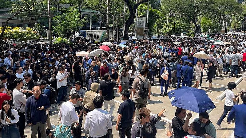 People gather on a street after a strong earthquake struck central Myanmar on Friday, earthquake monitoring services said, which affected Bangkok as well with hundreds of people pouring out of buildings in the Thai capital in panic after the tremors, in Bangkok, Thailand, March 28, 2025. REUTERS