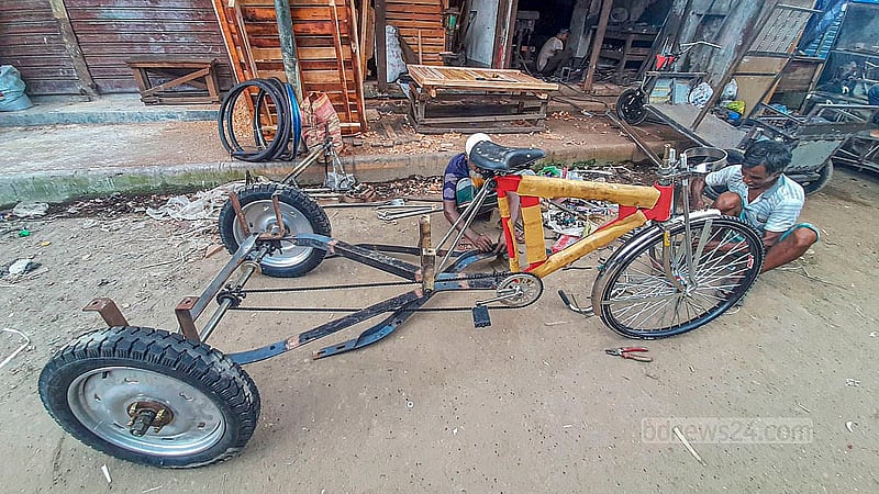 A workshop in Dhaka’s Rayerbazar is busy putting together battery-run rickshaws.