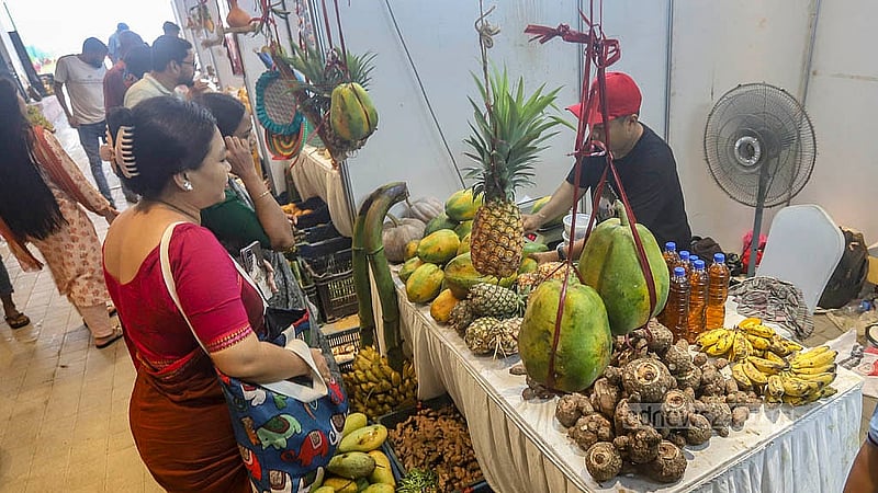 Visitors explore the various stalls at Bailey Road’s hill fruits fair. Photo: Abdullah al Momin