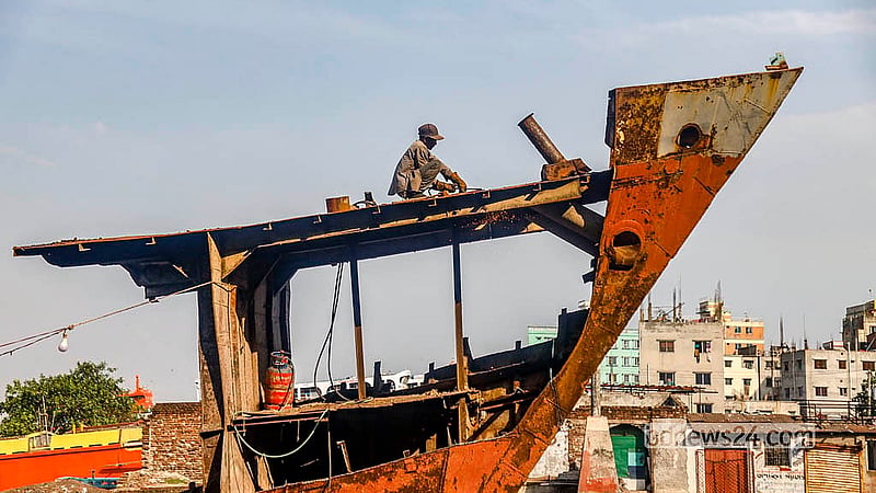 Workers cut up old ships under dangerous conditions at dockyards along the banks of the Buriganga River in Keraniganj. They allege that they are not paid fair wages for this high-risk work. Photo: Abdullah Al Momin