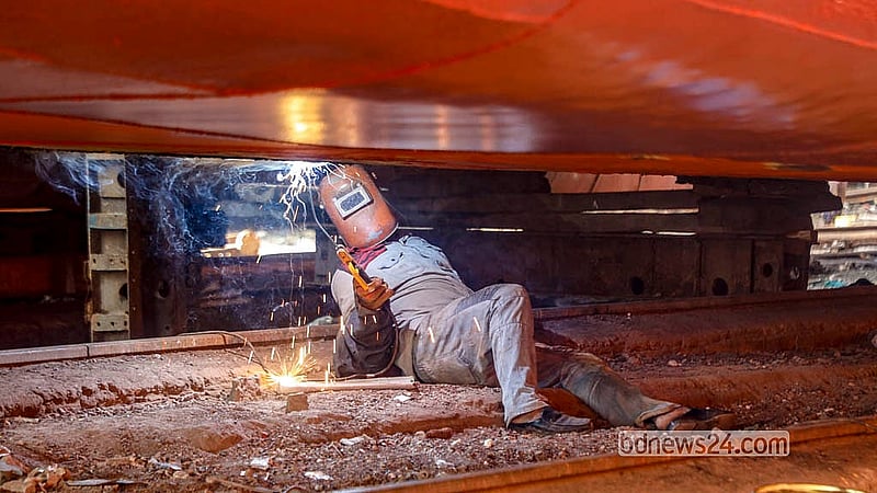 A worker repairs an old ship at a dockyard on the banks of the Buriganga River in Dhaka’s Keraniganj. They earn between Tk 800 and Tk 1,200 per day. Photo: Abdullah Al Momin