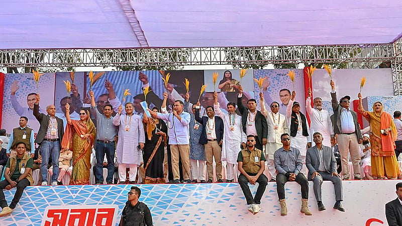BNP candidates from different constituencies hold sheaves of paddy with Tarique Rahman at an election meeting at the Government Rajendra College premises in Faridpur on Wednesday, Feb 4, 2026. Photo:BNP Media cell