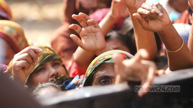 People desperately reach towards a TCB truck selling subsidised goods, hoping to get necessities for cheap before the stock runs out. Photo: Abdullah al Momin