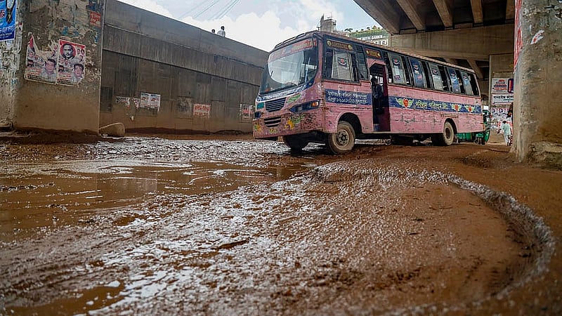 Deep potholes, mud and stagnant rainwater have left the road below the BRT flyover in Uttara’s Abdullahpur in poor condition for a long time.Photo: Mahmud Zaman Ovi