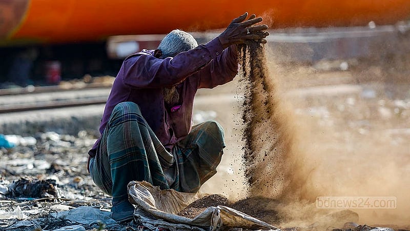 Matiur Rahman works hard to sift brass at the Keraniganj, using his hands instead of a machine to separate the metal. Photo: Mahmud Zaman Ovi