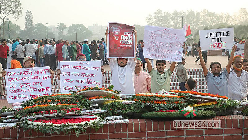 Protesters hold placards demanding justice for the murder of Sharif Osman bin Hadi at the National Memorial in Savar on Thursday, Mar 26, 2026.