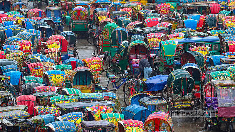 Battery-powered rickshaws fill the dumping station on the north side of Dhaka's Postogola Bridge. Photo: Abdullah Al Momin