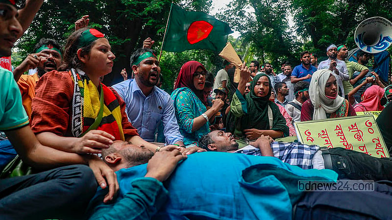 Protesters took up positions by lying on the road outside the chief advisor’s residence on Monday, Sept 30, 2024, demanding the age limit for applications to public sector jobs be raised to 35.