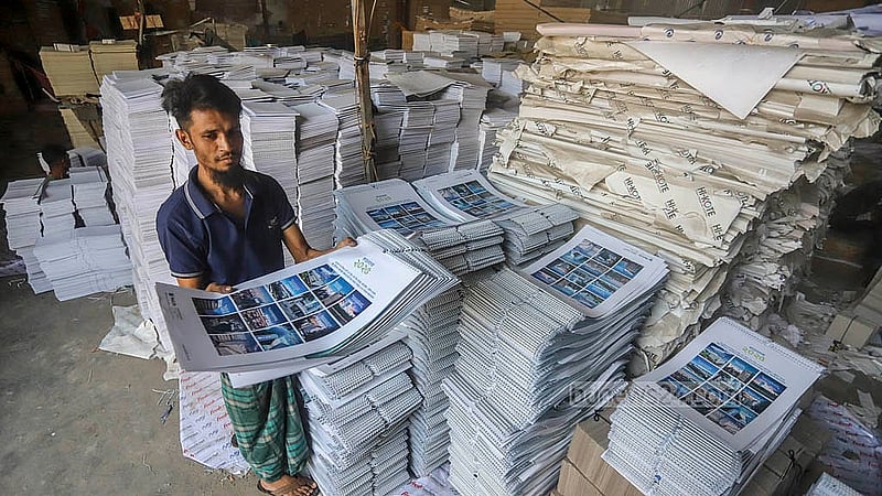 Workers trying hard to deliver the calendars to customers on time at the printing houses in Dhaka's Matuail ahead of the New Year 2025. Photo: Abdullah al Momin