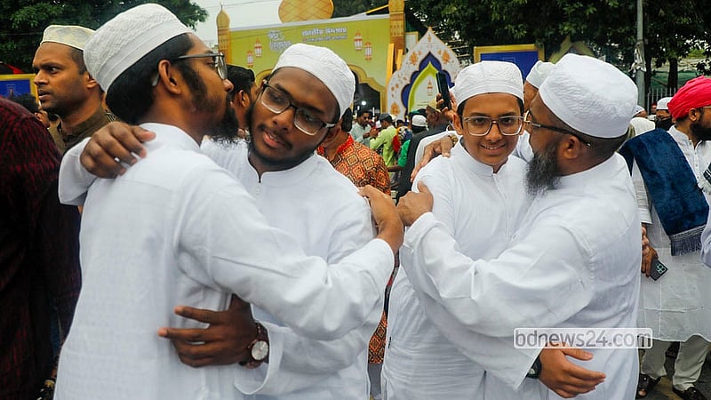 Devotees embrace after the Eid-ul-Fitr prayers at the National Eidgah on Saturday morning. Photo: Abdullah al Momin