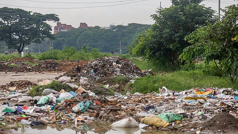 Garbage is dumped on one side of the Sher-e-Bangla Agricultural University research field. Photo: Mahmud Zaman Ovi