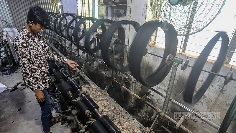 A worker is diligently winding thread, preparing it for the weaving process at Benarasi Palli in Dhaka’s Mirpur. Photo: Abdullah al Momin