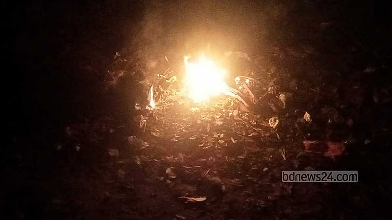 Four neighbourhood boys have lit a small fire to get a bit of warmth on a cold night in Rangpur city on Monday, Jan 20, 2025.