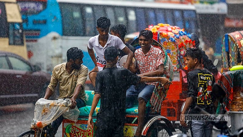 Young rickshaw passengers enjoy the rain at Mohammadpur bus stand in Dhaka on Monday, Jul 1, 2024. Photo: Mahmud Zaman Ovi