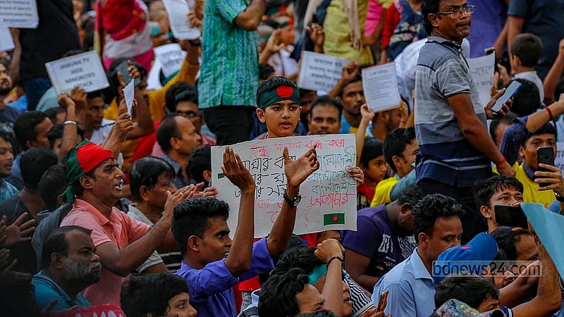 People of all ages hold placards at a protest rally by Hindu devotees at Shahbagh intersection in Dhaka on Saturday, Aug 10, 2024. Photo:Mahmud Zaman Ovi