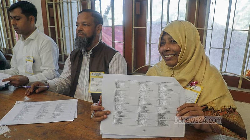 A polling agent shows a list of voters’ names at the mock voting organised by the Election Commission at Dhaka’s Sher-e-Bangla Nagar Government Girls' High School on Saturday, Nov 29, 2025. Photo: Abdullah al Momin