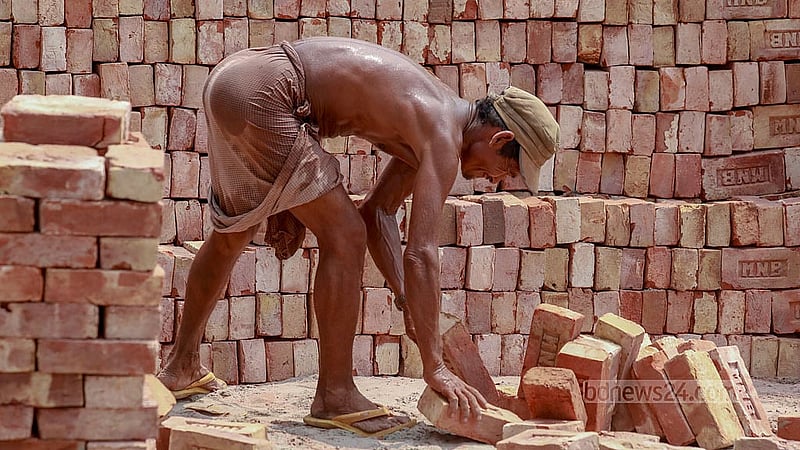 A labourer shines with sweat as he unloads bricks from a truck in Dhaka’s Gabtoli amid the intense summer heat. Photo: Muhammad Mostafigur Rahman