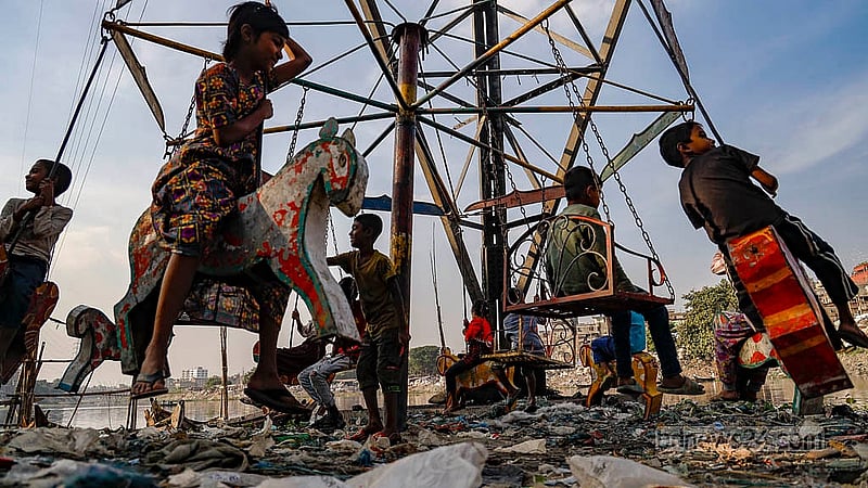 Children enjoy their time on a Merry Go Round in Dhaka’s Kamringarchar area, nestled along the banks of the soot black waters of the Buriganga River.Photo: Mahmud Zaman Ovi