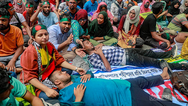 Protesters took up positions by lying on the road outside the chief advisor’s residence on Monday, Sept 30, 2024, demanding the age limit for applications to public sector jobs be raised to 35.