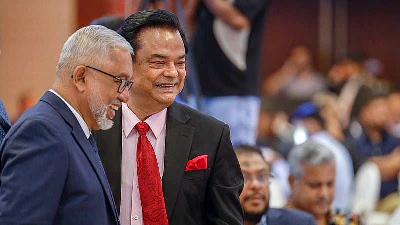 Musician Naquib Khan and magician Jewel Aich share a moment at the 19th anniversary celebration of bdnews24.com at the Radisson Blu Water Garden Hotel in Dhaka on Thursday, Oct 23, 2025.
