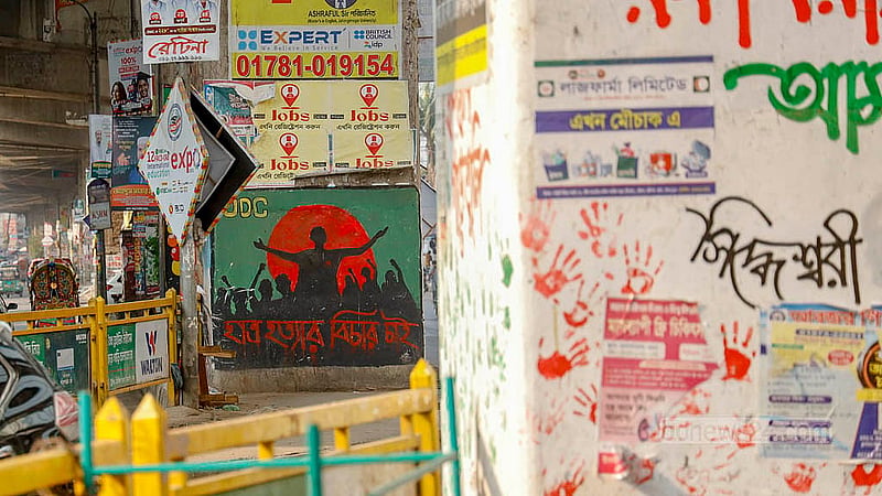 Posters and banners for different coaching centres and shops cover over the July Uprising graffiti on the pillars of the Mouchak-Moghbazar Flyover. Photo: Mahmud Zaman Ovi