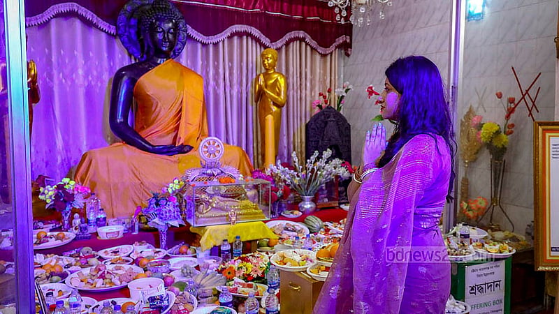A devotee prays in front of a statue of Lord Buddha in Dhaka on their largest festival Buddha Purnima on Wednesday, May 22, 2024. Photo: Mahmud Zaman Ovi
