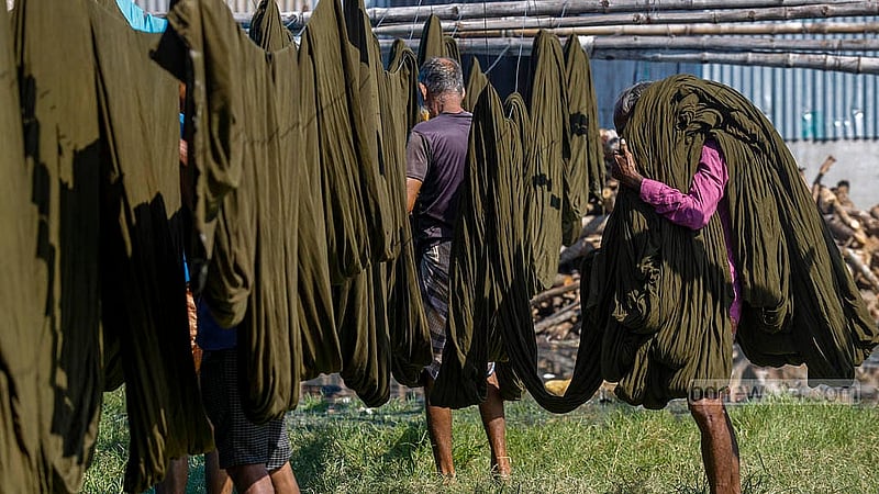 Workers spread dyed fabric from the factory to dry in the open field in Narayanganj’s Fatullah Post Office area. Photo: Mahmud Zaman Ovi
